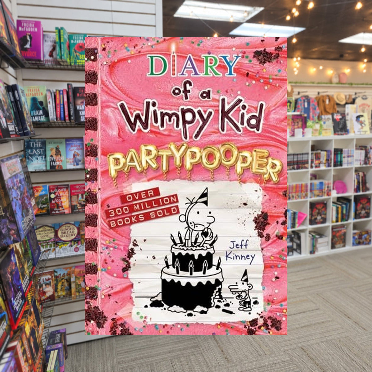 Diary of a Wimpy Kid: Partypooper by Jeff Kinney — actual cover on The Perk bookstore background