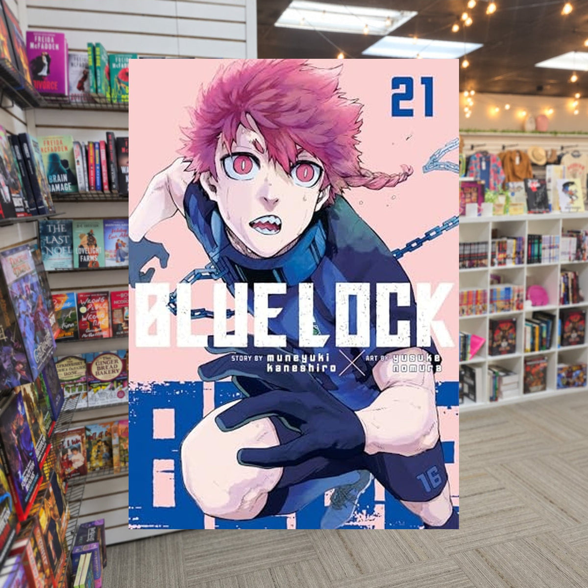 Blue Lock 21 by Muneyuki Kaneshiro — actual cover on The Perk bookstore background