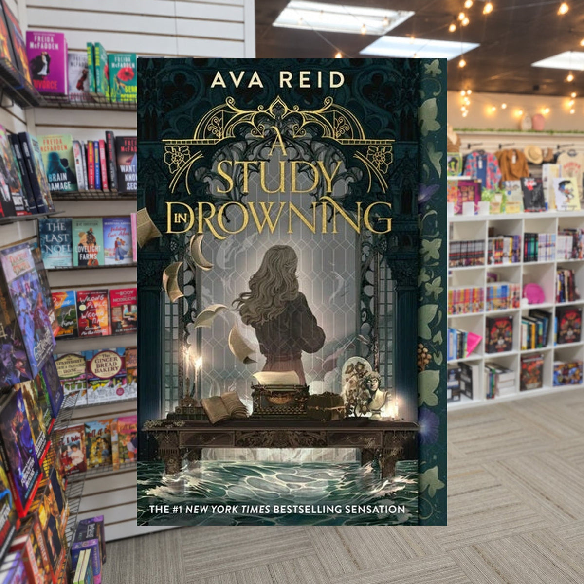 A Study in Drowning by Ava Reid — actual cover on The Perk bookstore background
