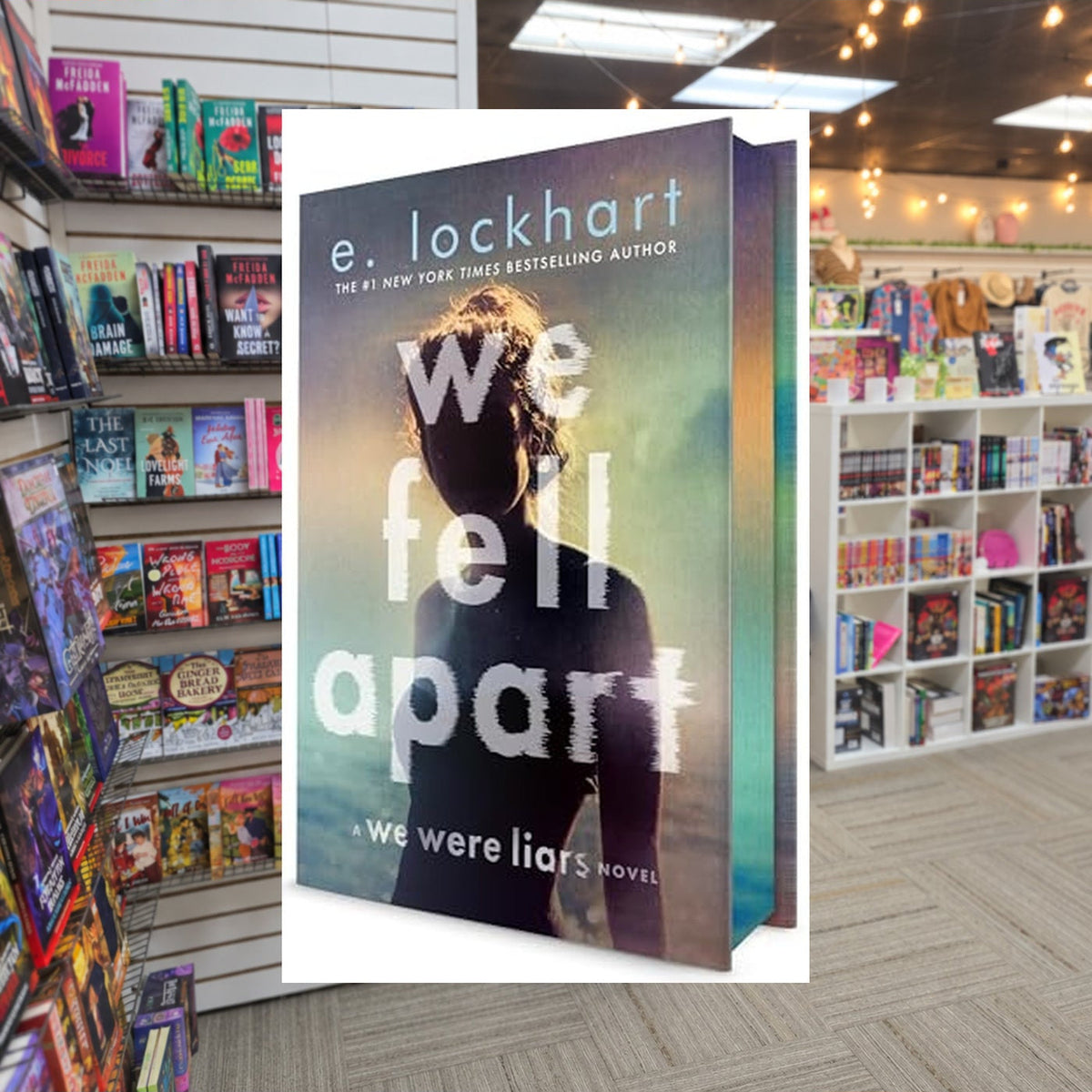 We Fell Apart by E. Lockhart — actual cover on The Perk bookstore background