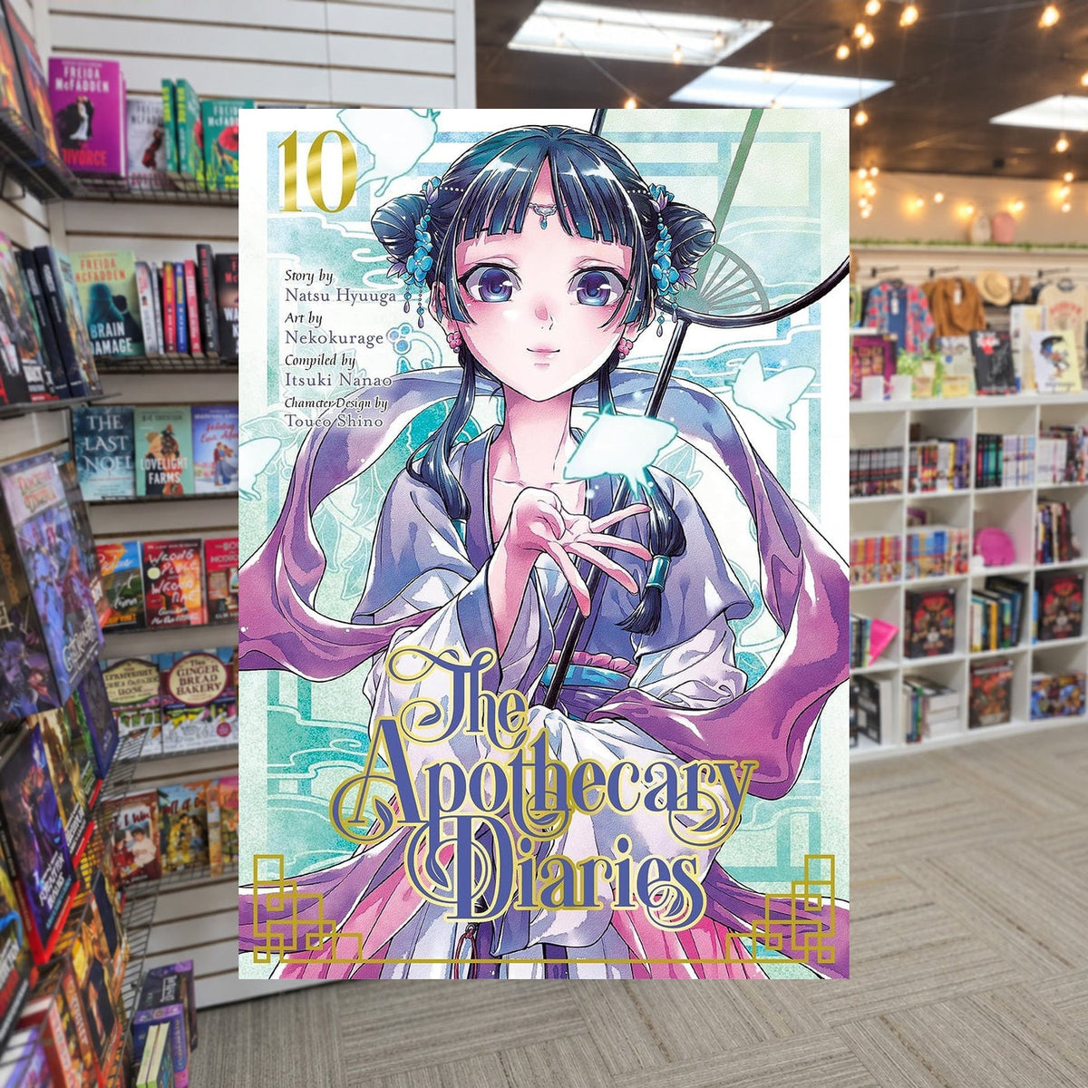 The Apothecary Diaries, Vol. 10 by Nekokurage and Natsu Hyuuga — actual cover on The Perk bookstore background