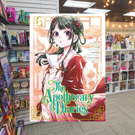 The Apothecary Diaries, Vol. 6 by Nekokurage and Natsu Hyuuga — actual cover on The Perk bookstore background