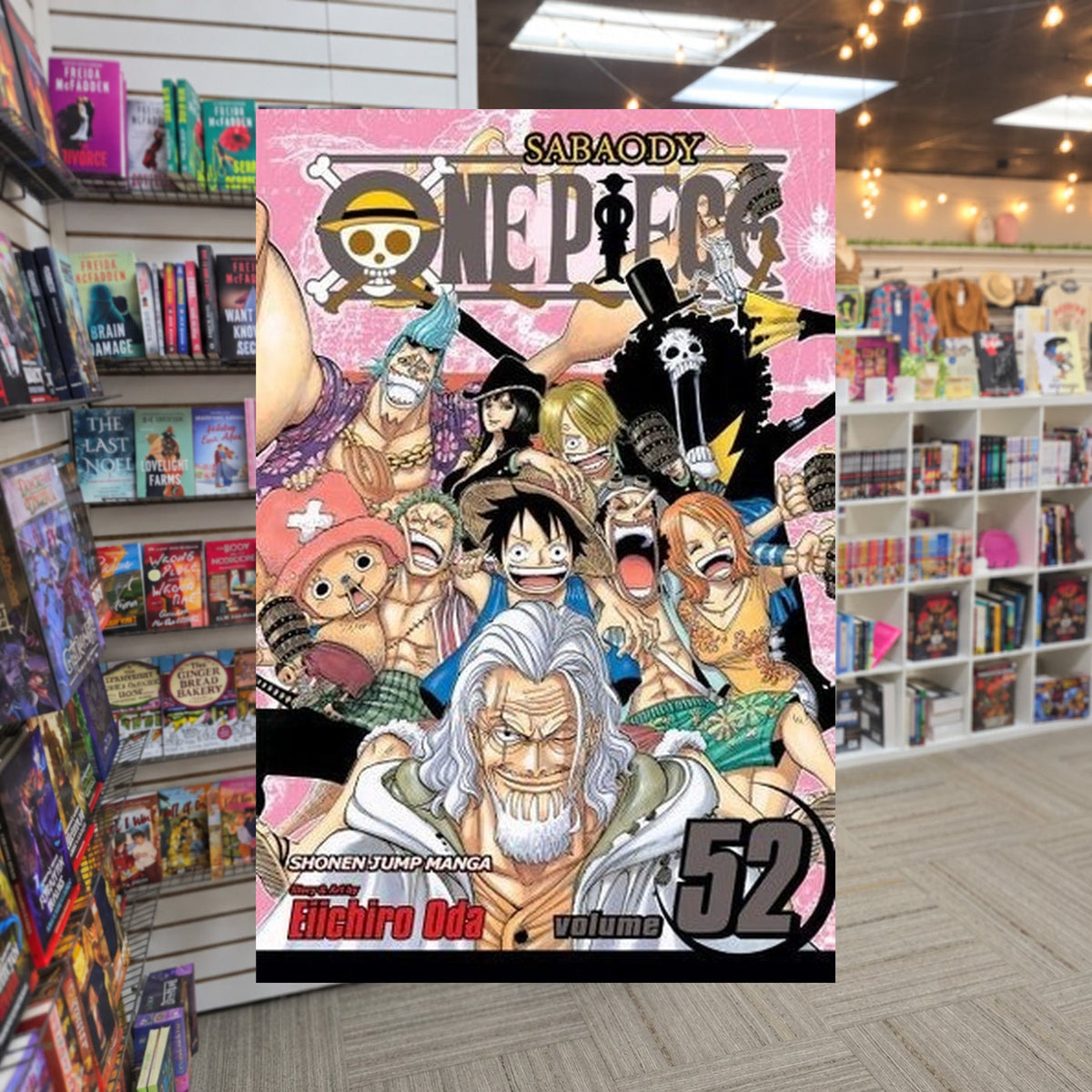 One Piece, Volume 52: Roger and Rayleigh by Eiichiro Oda — actual cover on The Perk bookstore background