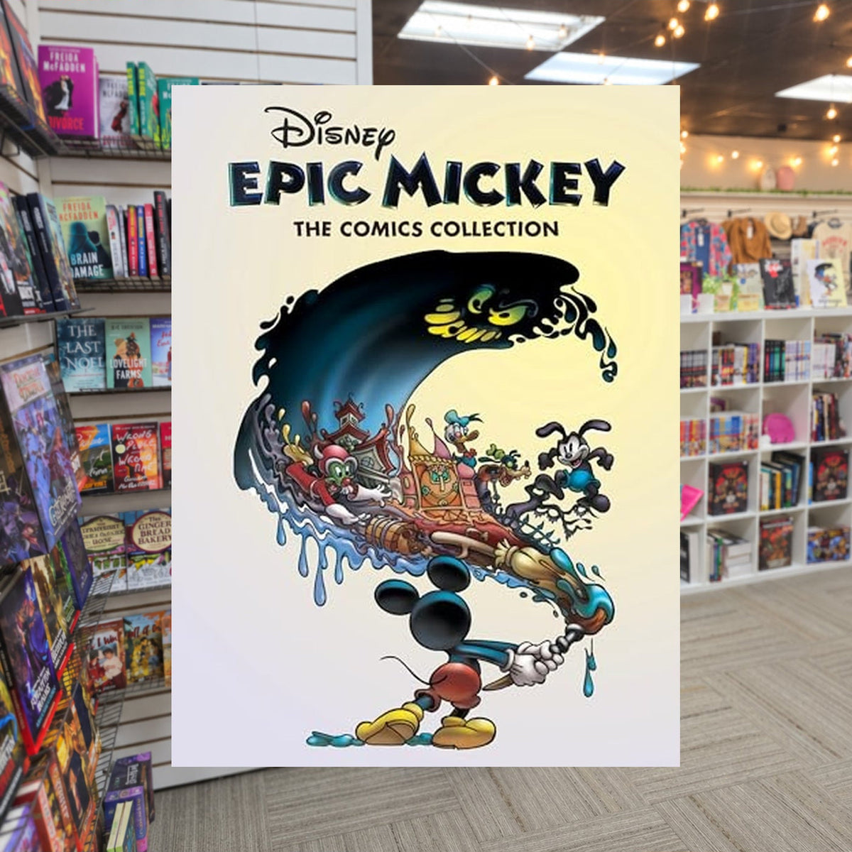 Disney Epic Mickey: The Comics Collection by Peter David — actual cover on The Perk bookstore background