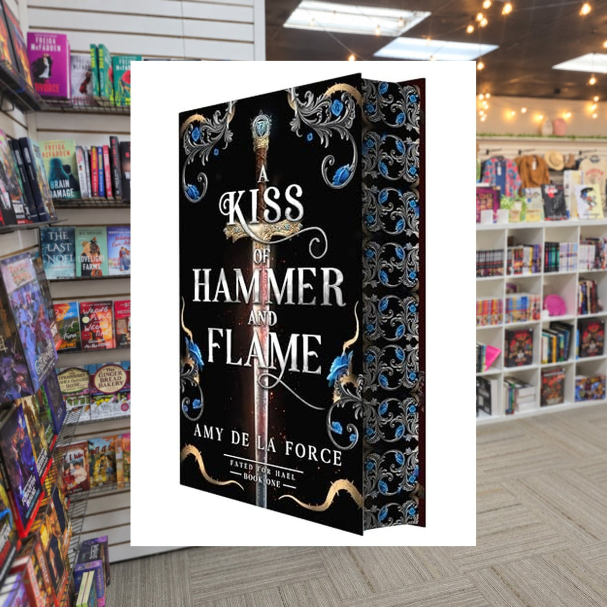 A Kiss of Hammer and Flame: The must-read, sizzling romantasy debut for fans of Throne of Glass  Amy de la Force — actual cover on The Perk bookstore background