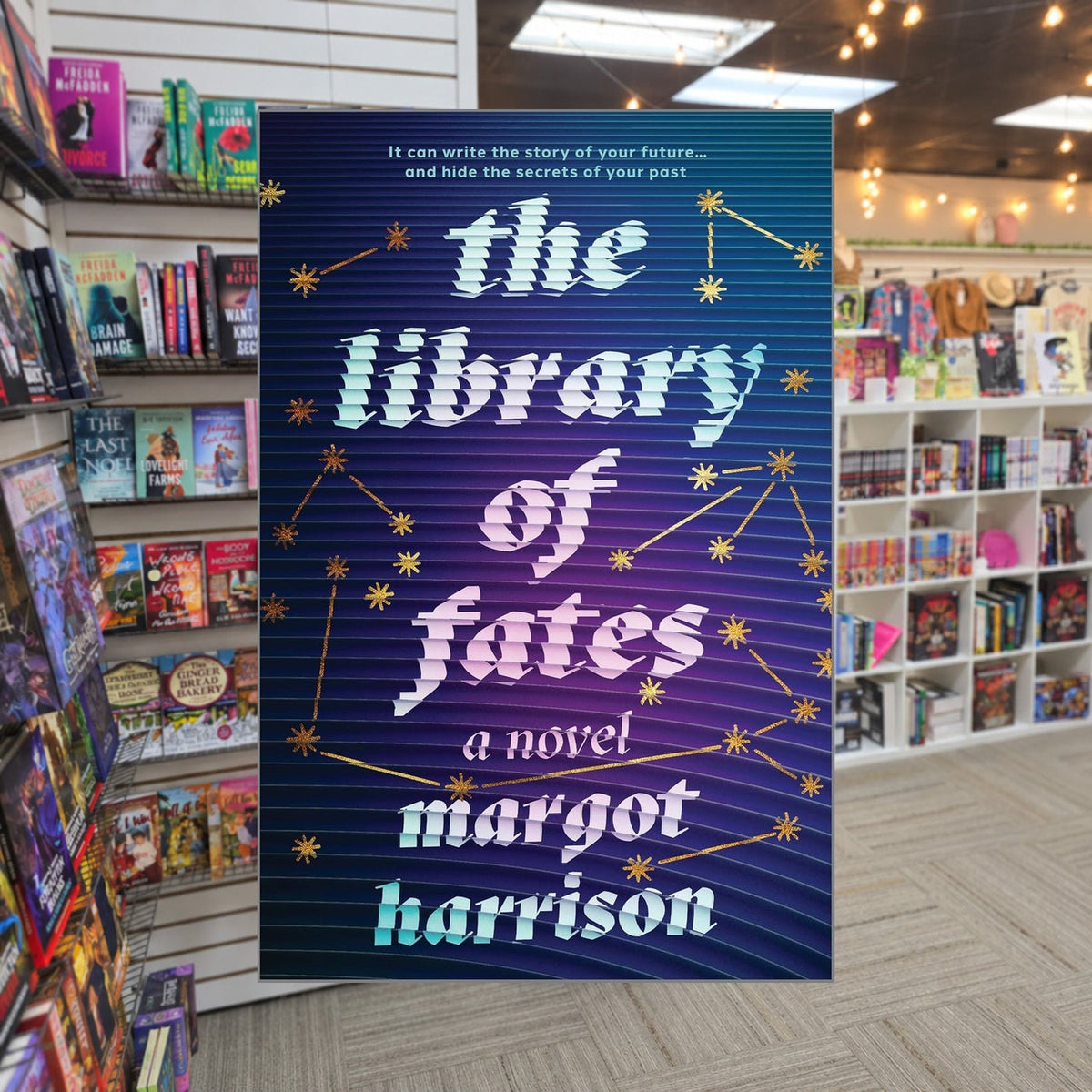The Library of Fates by Margot Harrison — actual cover on The Perk bookstore background