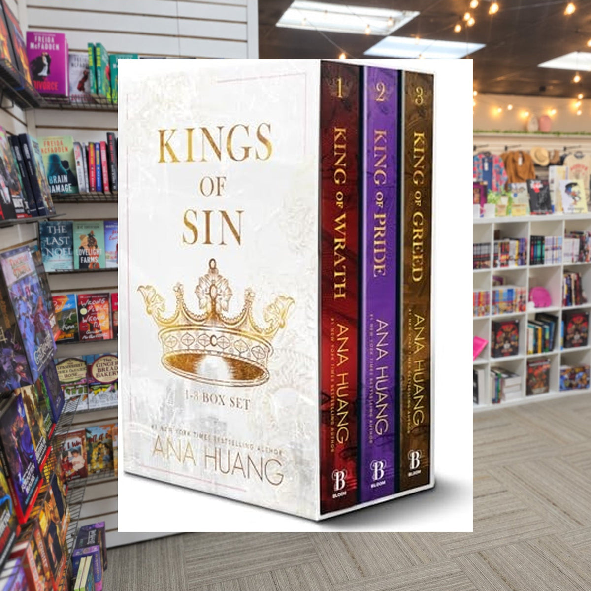 Kings of Sin Series Boxed Set, Books 1-3: King of Wrath, King of Pride, and King of Greed by Ana Huang — actual cover on The Perk bookstore background