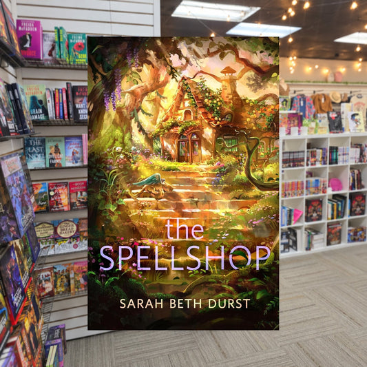 The Spellshop by Sarah Beth Durst — actual cover on The Perk bookstore background