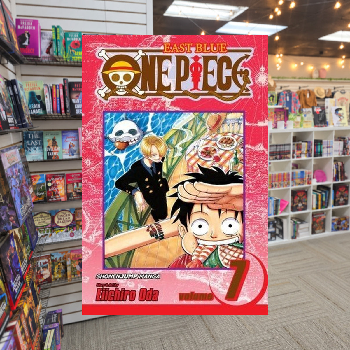 One Piece, Volume 7: The Crap-Geezer by Eiichiro Oda — actual cover on The Perk bookstore background
