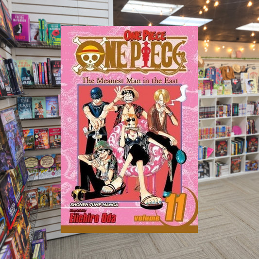 One Piece, Volume 11: The Meanest Man in the East by Eiichiro Oda — actual cover on The Perk bookstore background