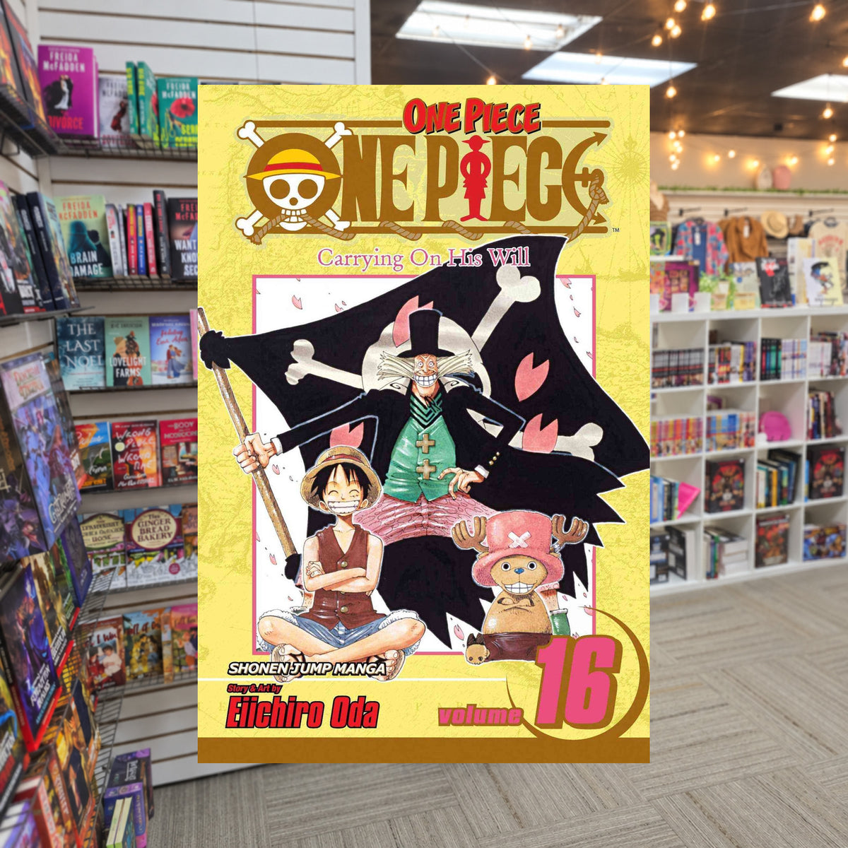 One Piece, Volume 16: Carrying On His Will by Eiichiro Oda — actual cover on The Perk bookstore background