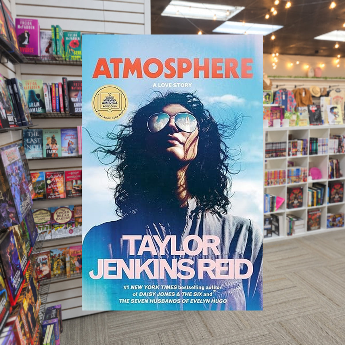 Atmosphere by Taylor Jenkins Reid — actual cover on The Perk bookstore background