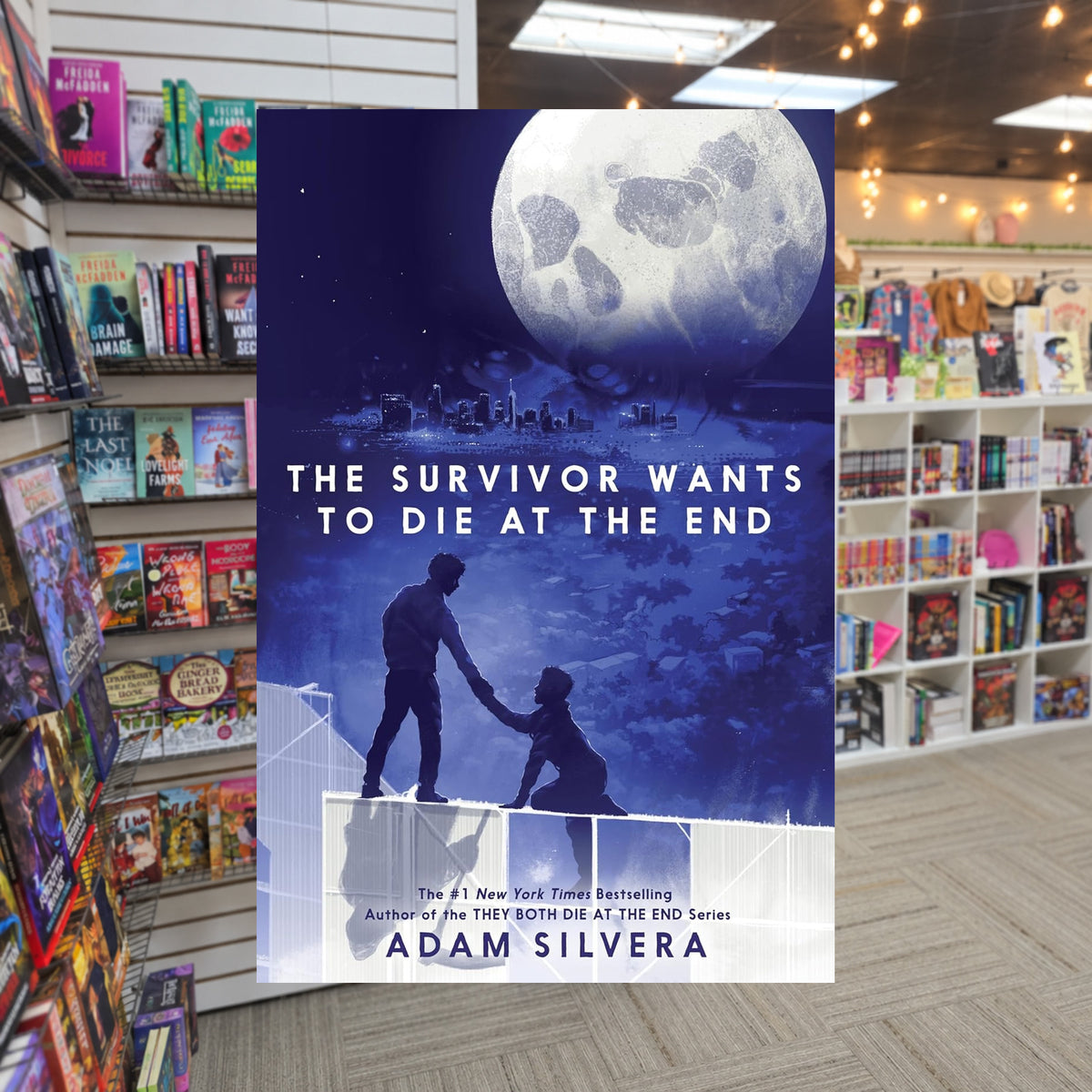 The Survivor Wants to Die at the End by Adam Silvera — actual cover on The Perk bookstore background