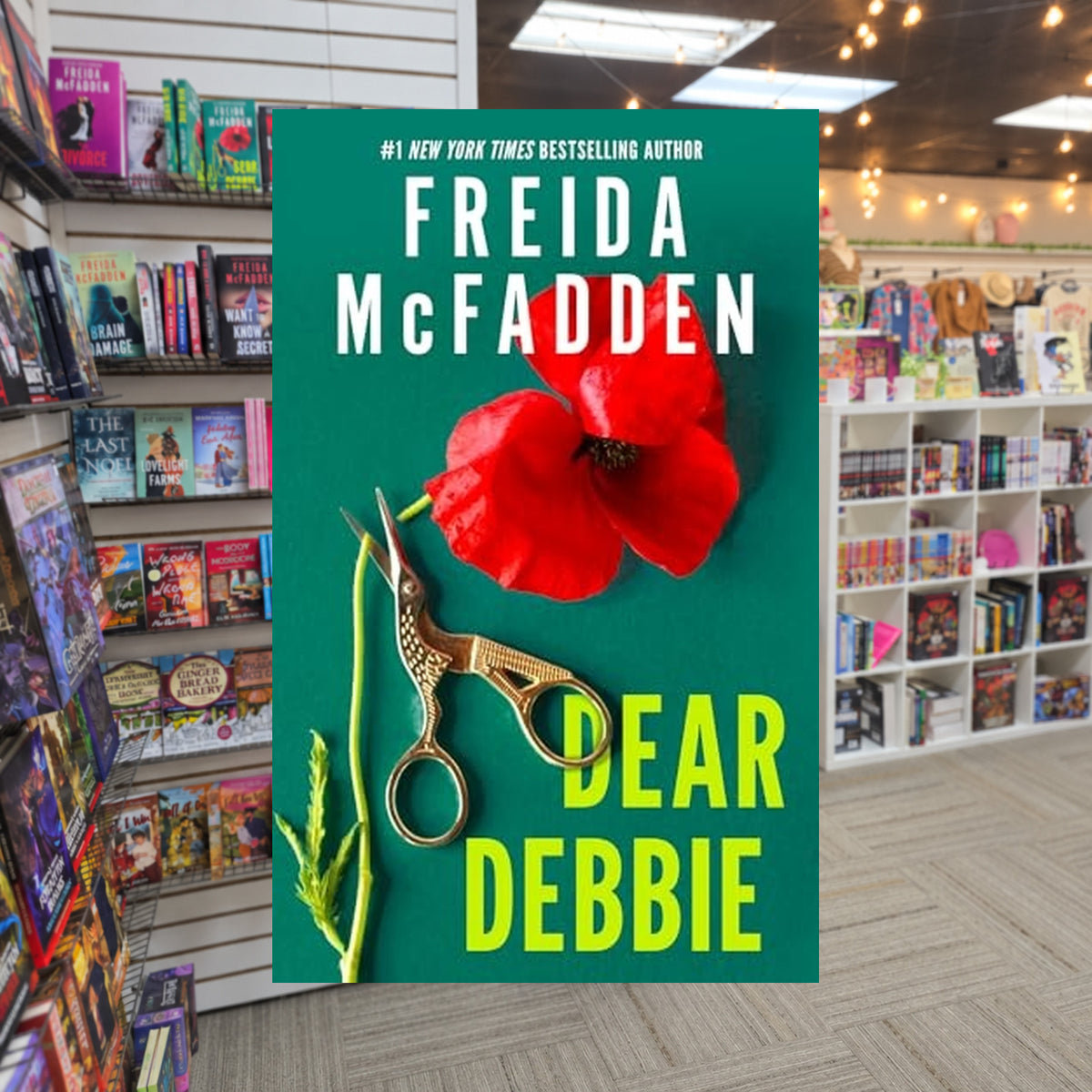 Dear Debbie by Freida McFadden — actual cover on The Perk bookstore background