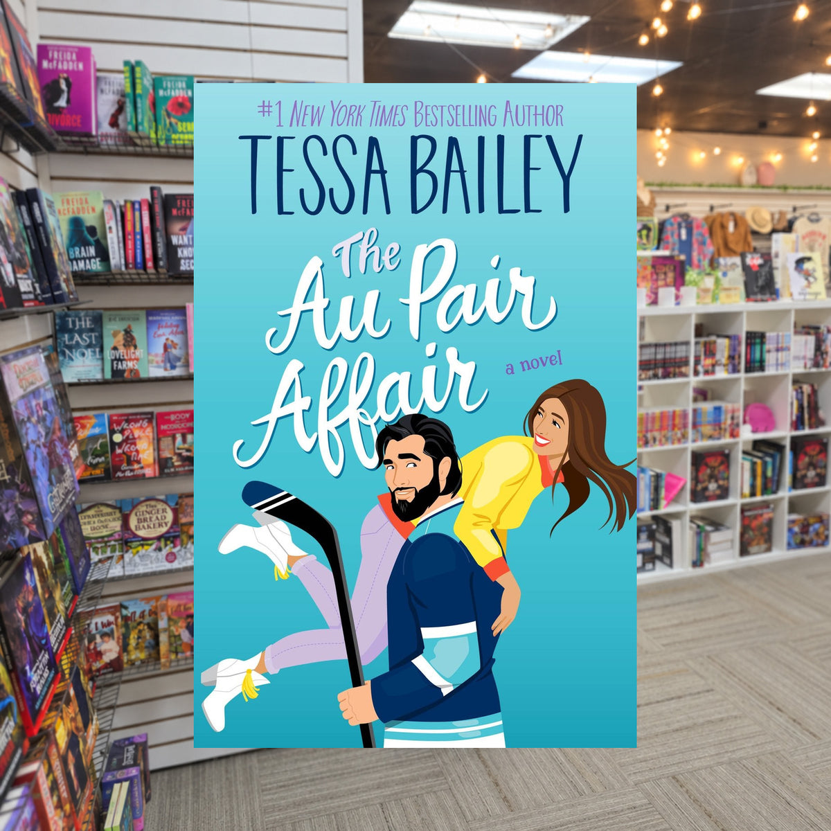 The Au Pair Affair by Tessa Bailey — actual cover on The Perk bookstore background
