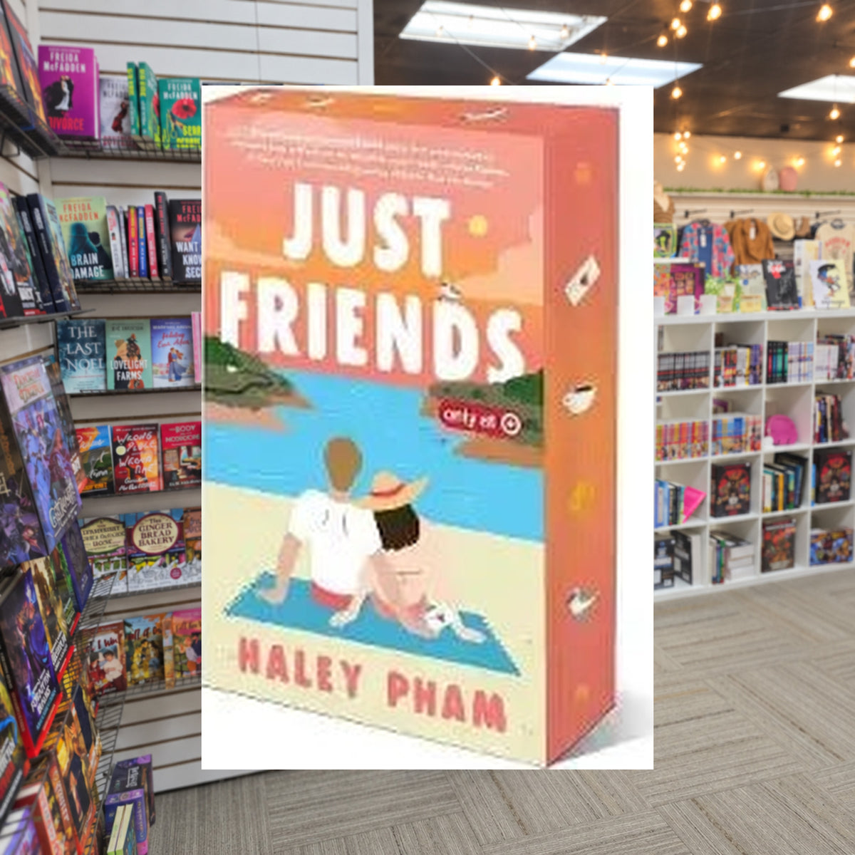 Just Friends by Haley Pham paperback — actual cover on The Perk bookstore background