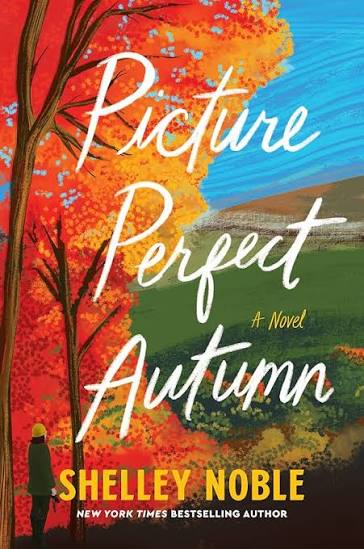 Picture Perfect Autumn by Shelley Noble paperback book cover featuring vibrant orange autumn leaves, a scenic countryside landscape and a colorful fall sky