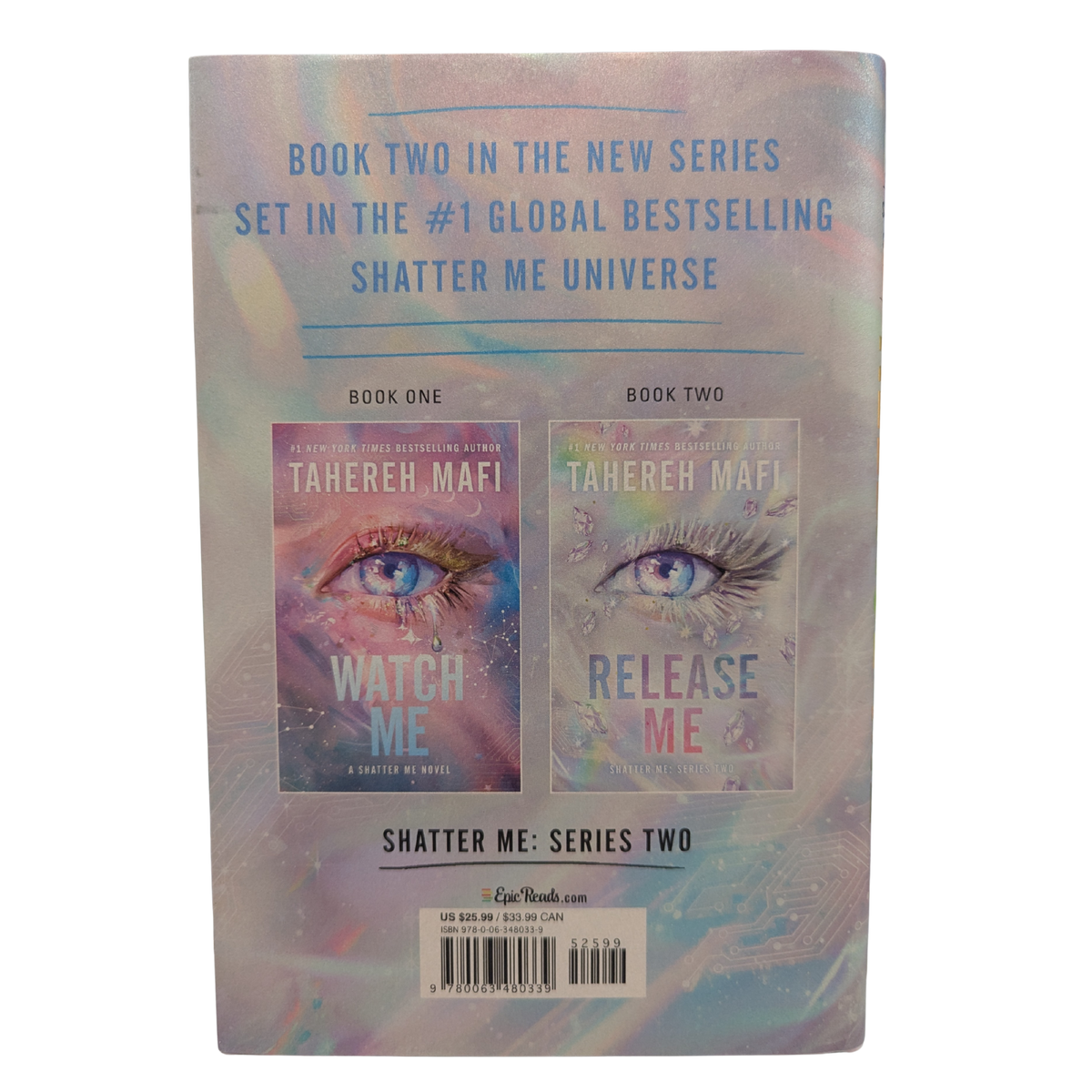 Release Me by Tahereh Mafi Deluxe Limited Edition hardcover featuring a shimmering silver holographic cover with a large blue eye, iridescent details, and holographic page edges. Shatter Me Series Two Book 2.