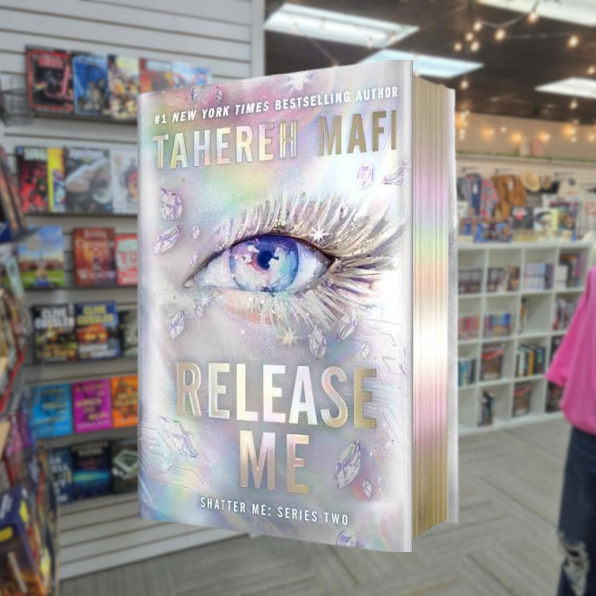 Release Me by Tahereh Mafi Deluxe Limited Edition hardcover featuring a shimmering silver holographic cover with a large blue eye, iridescent details, and holographic page edges. Shatter Me Series Two Book 2.