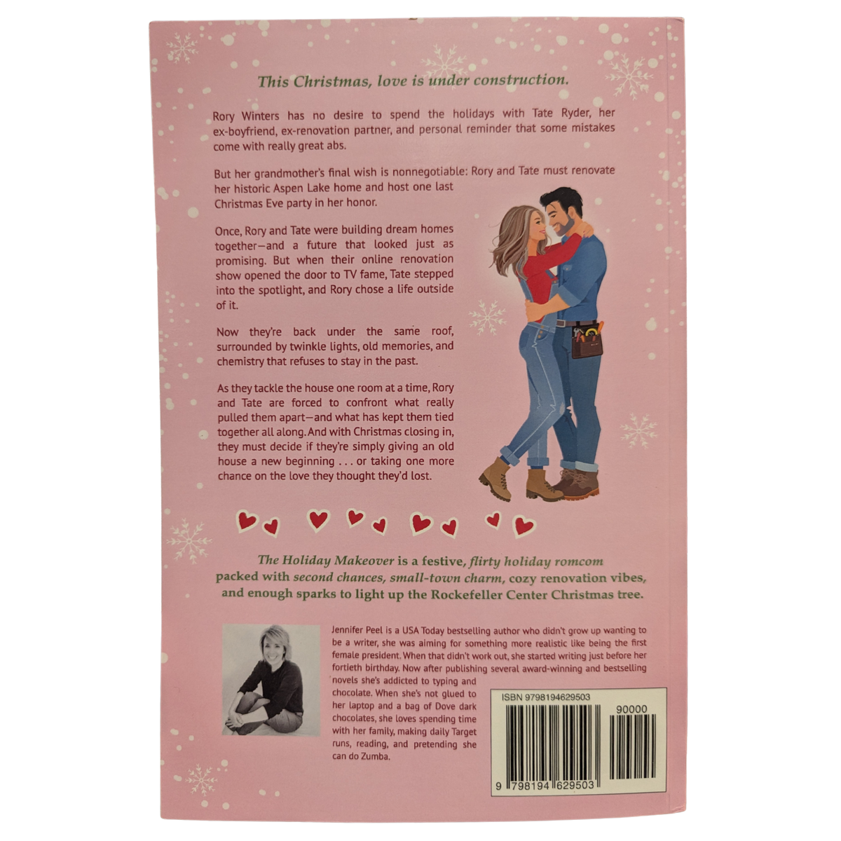 The Holiday Makeover by Jennifer Peel Christmas romance book cover featuring a pink snowy background, an illustrated blonde woman holding a paint roller, a dark-haired man, and a decorated Christmas tree.