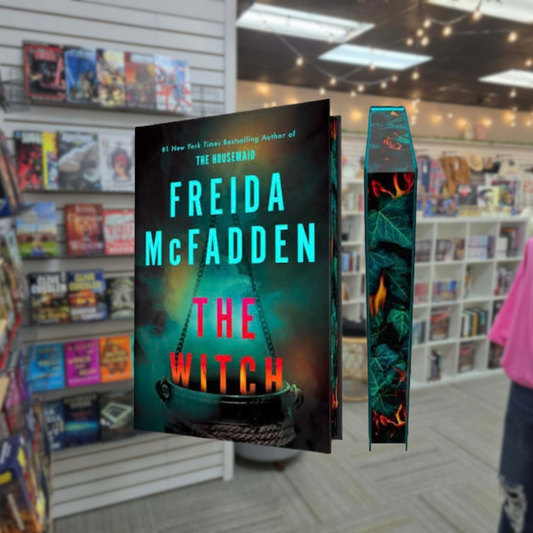 The Witch by Freida McFadden special edition hardcover book featuring turquoise lettering, colorful flames, a bubbling cauldron and decorative sprayed page edges